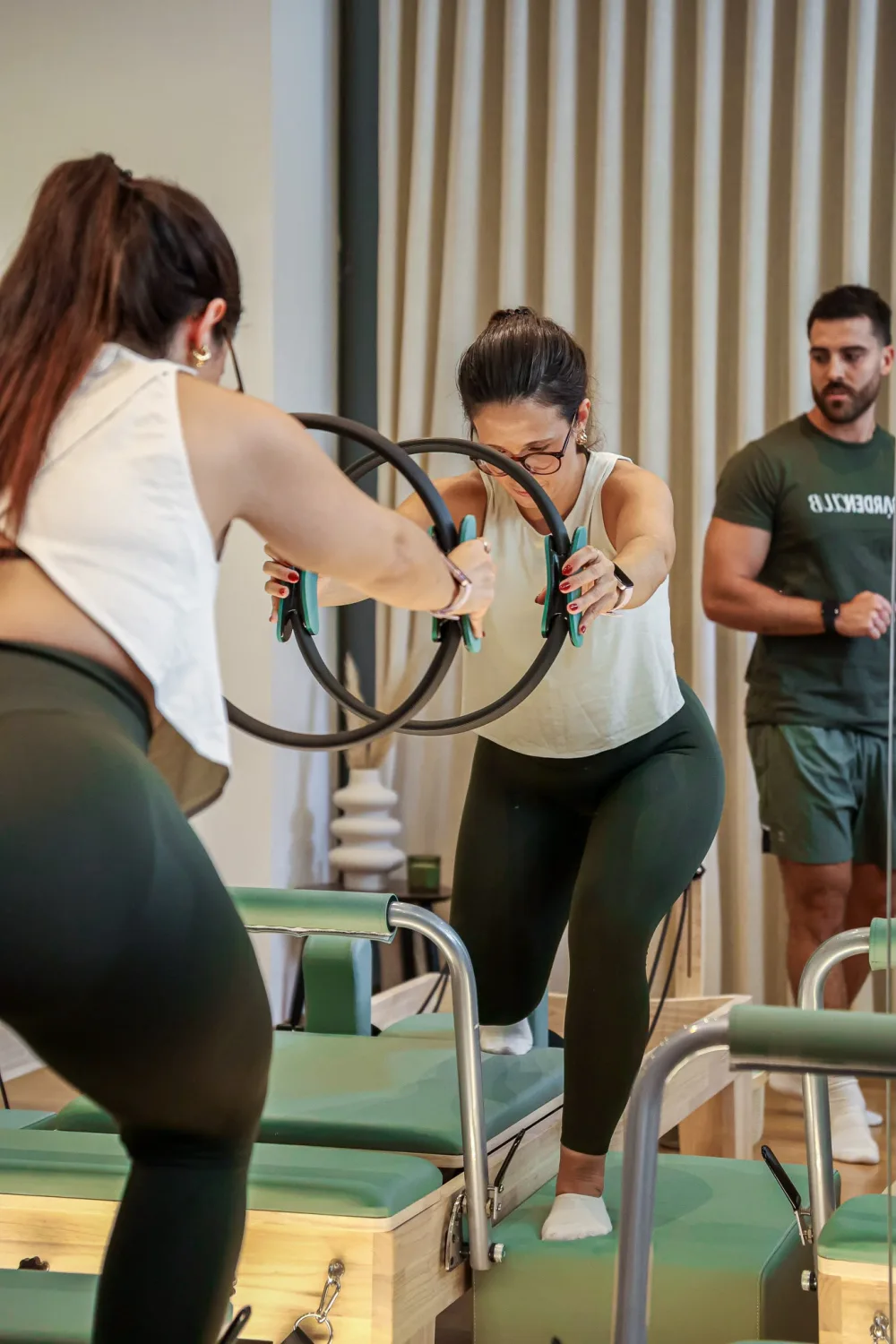 Alunas a treinar com o círculo de Pilates durante uma aula de Reformer